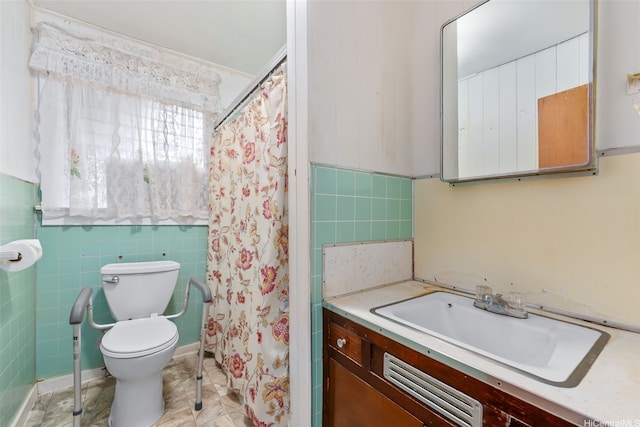 bathroom with toilet, a shower with curtain, tile walls, and vanity