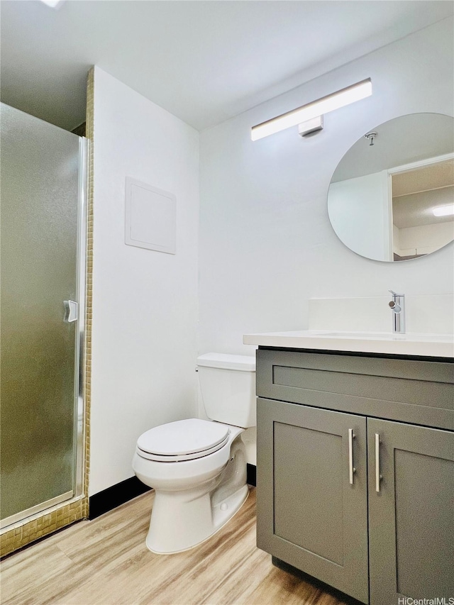 1188 Bishop St Unit 601, Honolulu, HI 96813 - bathroom with wood finished floors, vanity, and a stall shower