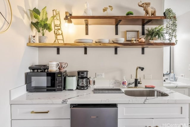 bar featuring black microwave, stainless steel dishwasher, and a sink