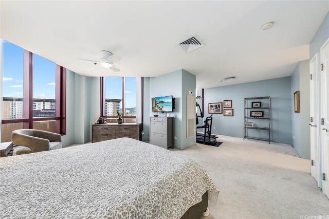 725 Kapiolani Blvd Unit 3503, Honolulu, HI 96813 - bedroom featuring a wall of windows, ceiling fan, light carpet, and visible vents