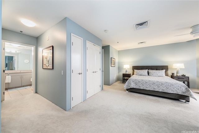 725 Kapiolani Blvd Unit 3503, Honolulu, HI 96813 - bedroom featuring two closets, visible vents, light carpet, and ensuite bath