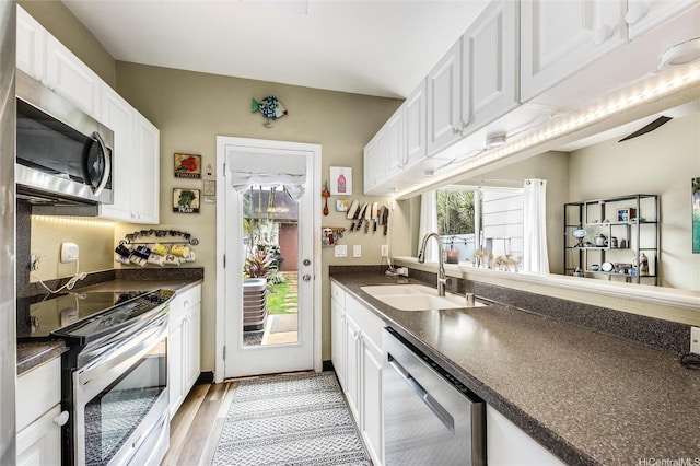 91-1059 Keoneula Blvd Unit F3, Ewa Beach, HI 96706 - kitchen with white cabinets, dark countertops, stainless steel appliances, and a sink