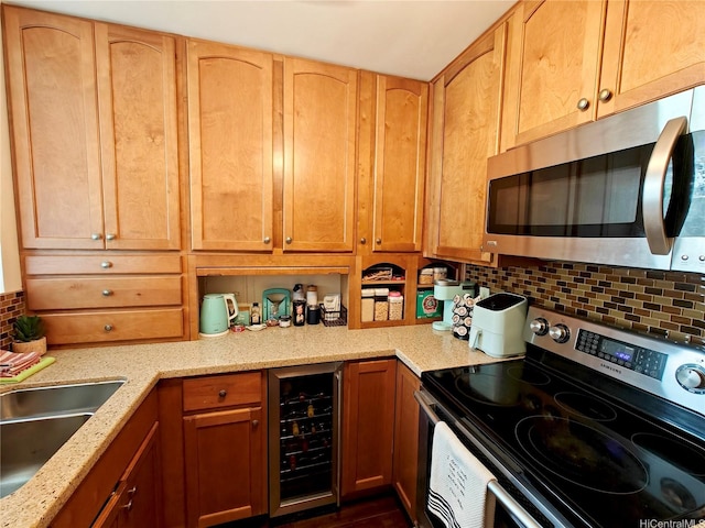 kitchen featuring stainless steel appliances, wine cooler, backsplash, light stone countertops, and a sink
