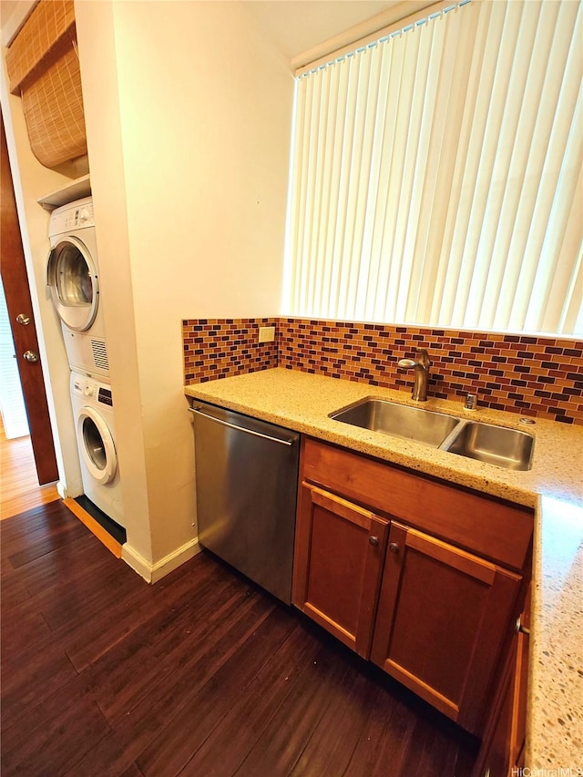 965 Prospect St Unit 307, Honolulu, HI 96822 - kitchen featuring stainless steel dishwasher, estacked washer and dryer, tasteful backsplash, a sink, and dark wood-type flooring