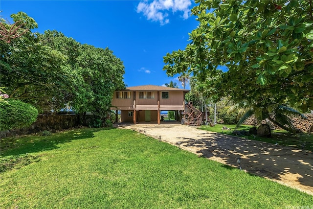 84-215 Makau St, Waianae, HI 96792 - view of front facade with driveway, stairs, a front lawn, and a carport