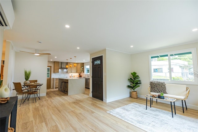 interior space featuring light wood-style flooring, baseboards, recessed lighting, and plenty of natural light