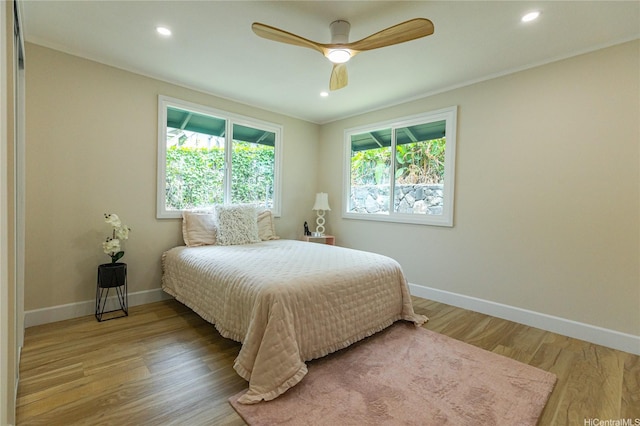 bedroom featuring wood finished floors, baseboards, a ceiling fan, and recessed lighting