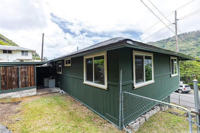 view of side of property featuring fence