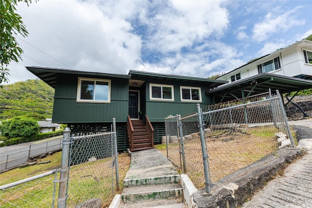view of front of house with fence and a gate