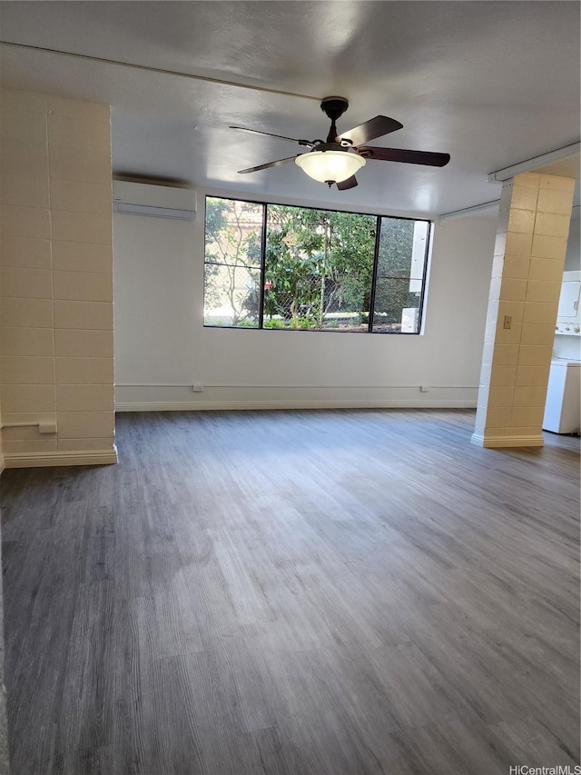 2050 Nuuanu Ave Unit 109, Honolulu, HI 96817 - spare room featuring a wall mounted air conditioner, wood finished floors, ceiling fan, and plenty of natural light