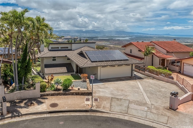 92-1200 Uahanai St, Kapolei, HI 96707 - view of front of property featuring a garage, a tile roof, concrete driveway, and solar panels