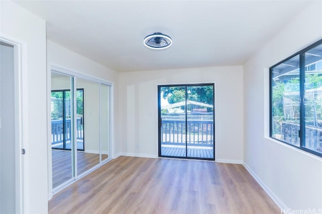 spare room with light wood-style floors and baseboards