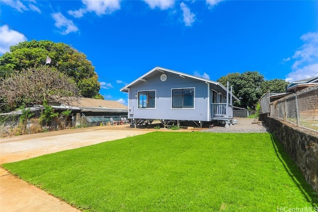 view of front of property with a front yard and fence