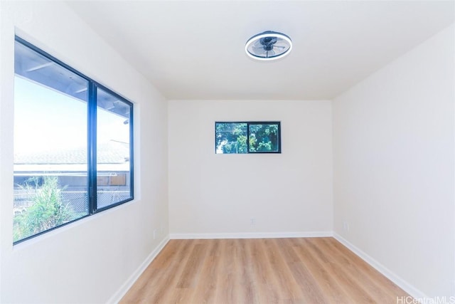 empty room with light wood-type flooring and baseboards