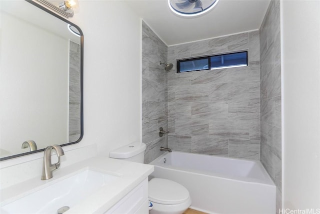 bathroom featuring toilet, bathing tub / shower combination, and vanity