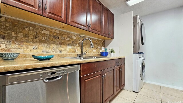 2415 Ala Wai Blvd Unit 1401, Honolulu, HI 96815 - kitchen with dishwasher, a sink, light tile patterned floors, decorative backsplash, and stacked washing machine and dryer