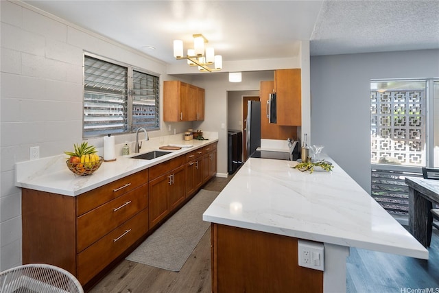 94-313 Ulukoa St, Mililani, HI 96789 - kitchen featuring a sink, dark wood-style floors, stove, brown cabinets, and a chandelier