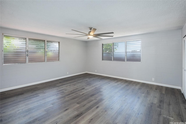 94-313 Ulukoa St, Mililani, HI 96789 - empty room featuring ceiling fan, dark wood-style floors, a textured ceiling, concrete block wall, and baseboards