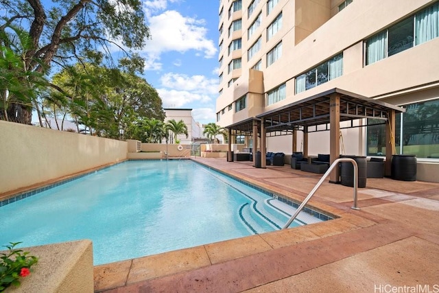 1314 Kalakaua Ave Unit 906, Honolulu, HI 96826 - community pool with an outdoor living space and a patio area