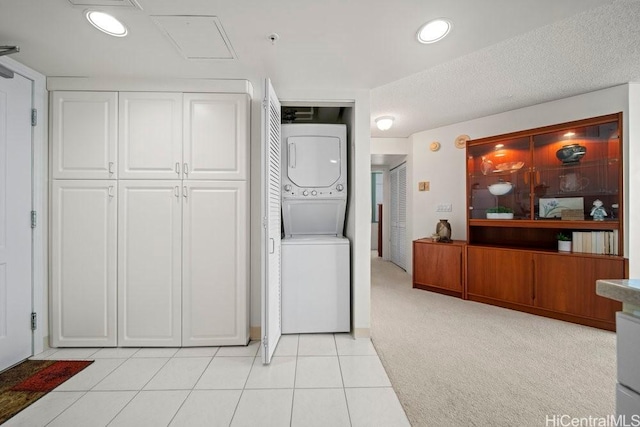 1314 Kalakaua Ave Unit 906, Honolulu, HI 96826 - clothes washing area featuring stacked washer and clothes dryer and light tile patterned floors
