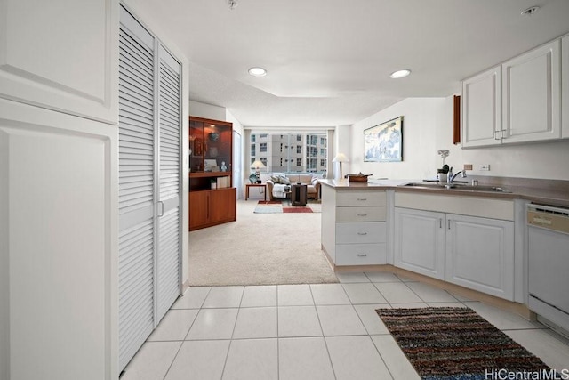 1314 Kalakaua Ave Unit 906, Honolulu, HI 96826 - kitchen featuring white dishwasher, light carpet, a sink, light tile patterned flooring, and open floor plan