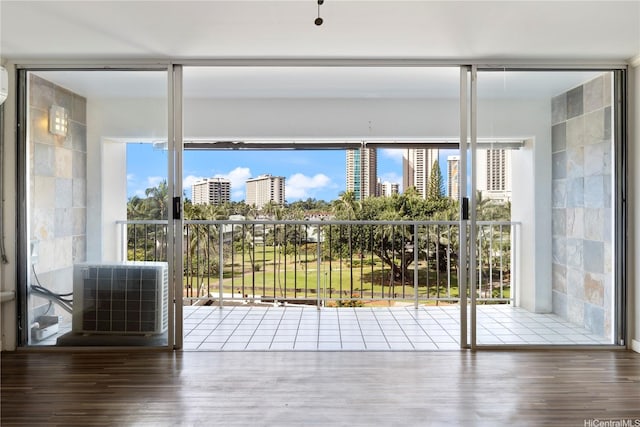 430 Keoniana St Unit 204, Honolulu, HI 96815 - doorway to outside featuring a view of city, wood finished floors, and a healthy amount of sunlight