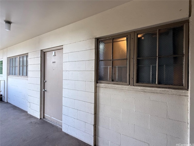 entrance to property featuring concrete block siding