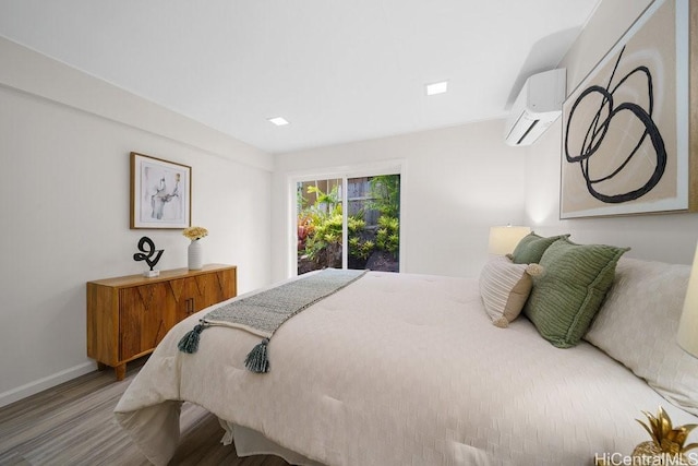 1782 Laukahi St, Honolulu, HI 96821 - bedroom featuring a wall mounted air conditioner, baseboards, and wood finished floors