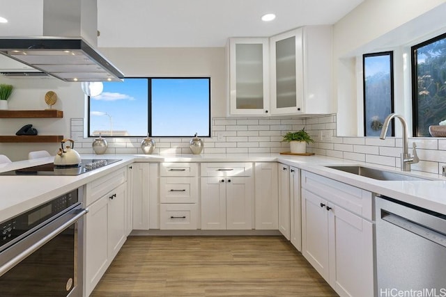 1782 Laukahi St, Honolulu, HI 96821 - kitchen with a sink, white cabinetry, wall chimney exhaust hood, appliances with stainless steel finishes, and recessed lighting