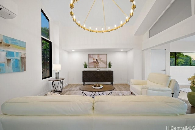 1782 Laukahi St, Honolulu, HI 96821 - living room with a wall mounted AC, wood finished floors, a high ceiling, and baseboards
