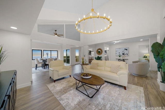 1782 Laukahi St, Honolulu, HI 96821 - living room with high vaulted ceiling, baseboards, wood finished floors, and ceiling fan with notable chandelier