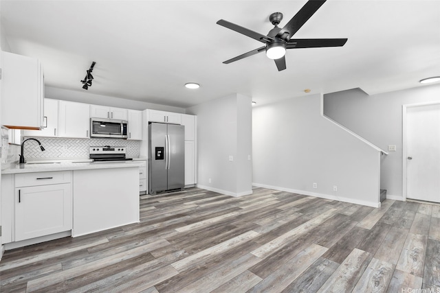 91-241 Makalauna Pl Unit 15, Ewa Beach, HI 96706 - kitchen featuring appliances with stainless steel finishes, a ceiling fan, white cabinetry, light countertops, and light wood-type flooring