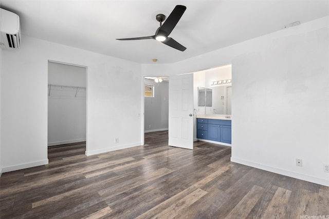 91-241 Makalauna Pl Unit 15, Ewa Beach, HI 96706 - unfurnished bedroom featuring a wall unit AC, dark wood-style flooring, a closet, ensuite bathroom, and a ceiling fan