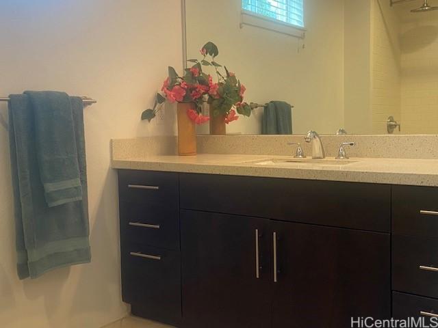 bathroom featuring walk in shower and vanity