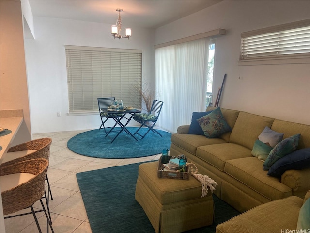 living area with light tile patterned floors and a notable chandelier