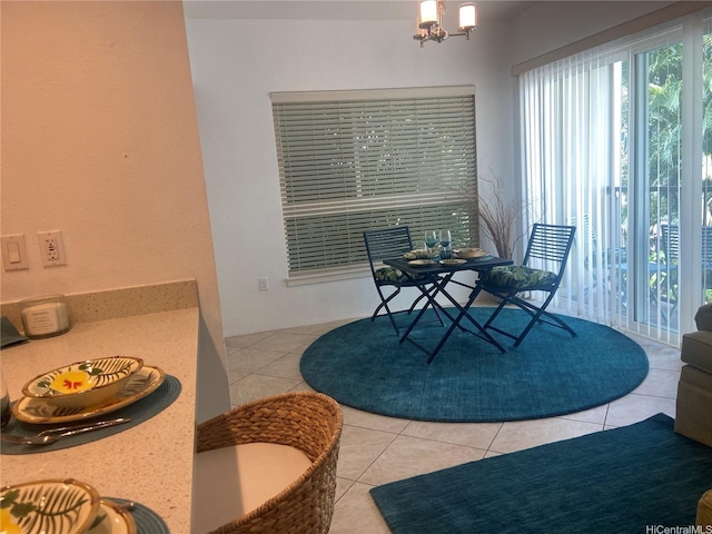 dining space featuring tile patterned floors and a chandelier