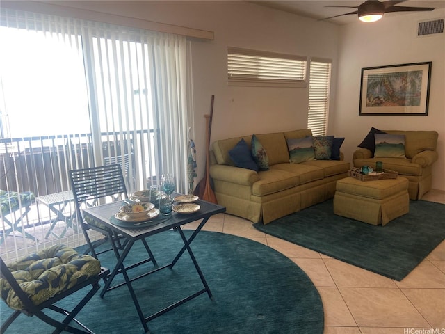 living area with visible vents, light tile patterned floors, and ceiling fan