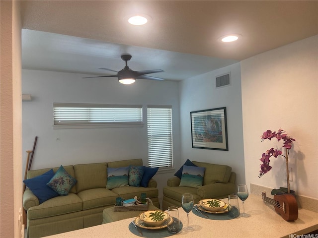 living area with visible vents, a ceiling fan, and recessed lighting