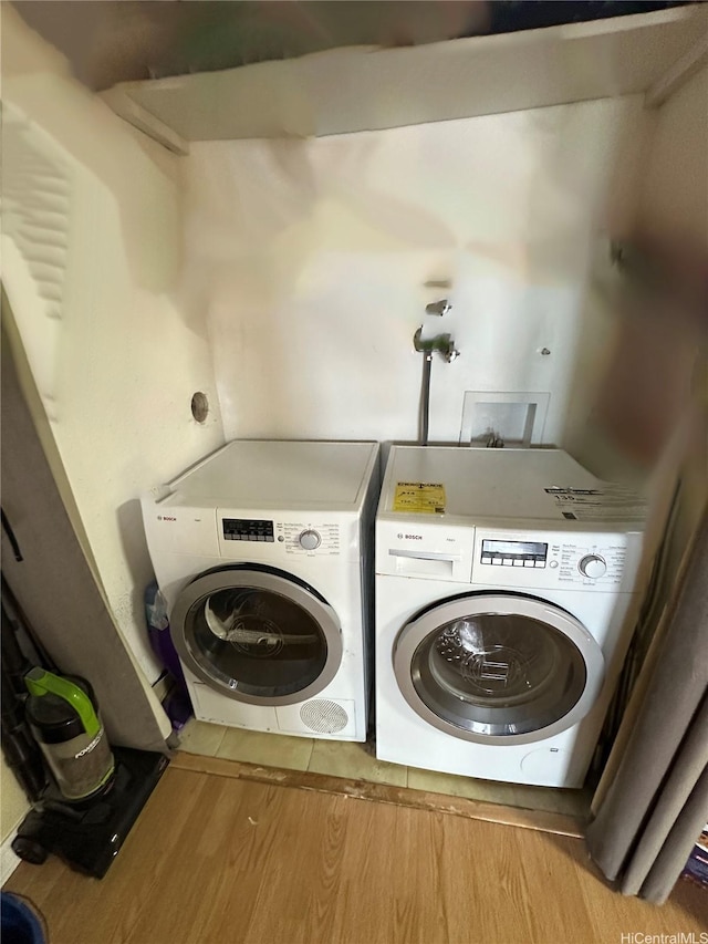 2333 Kapiolani Blvd Unit 905, Honolulu, HI 96826 - washroom with washer and dryer and wood finished floors
