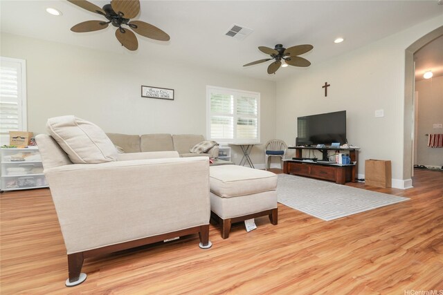 living area with ceiling fan, arched walkways, wood finished floors, recessed lighting, and baseboards