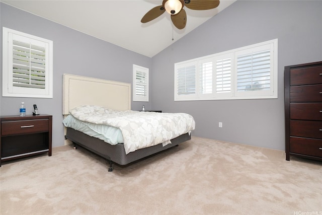 carpeted bedroom with vaulted ceiling and ceiling fan