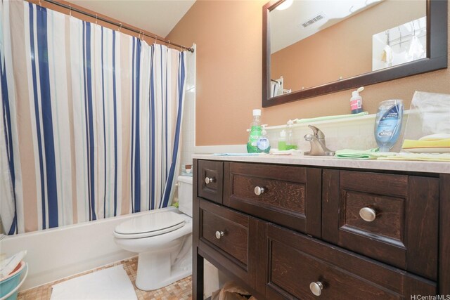 bathroom with toilet, vanity, and shower / bath combo with shower curtain