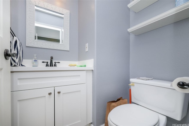half bath featuring toilet and vanity