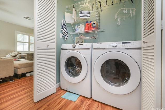 91-1153 Kaileonui St, Ewa Beach, HI 96706 - laundry area with independent washer and dryer and wood finished floors