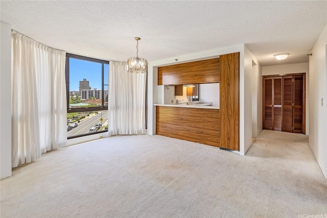 5090 Likini St Unit 501, Honolulu, HI 96818 - empty room with light colored carpet, a chandelier, and a textured ceiling