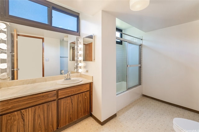 5090 Likini St Unit 501, Honolulu, HI 96818 - bathroom with tile patterned floors, toilet, shower / bath combination with glass door, vanity, and baseboards