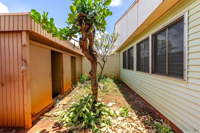 view of side of home featuring fence