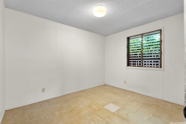 spare room featuring a textured ceiling