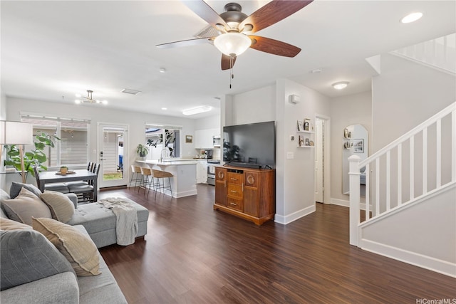 91-1322 Keoneula Blvd Unit 403, Ewa Beach, HI 96706 - living room with stairway, baseboards, dark wood-style floors, and a ceiling fan