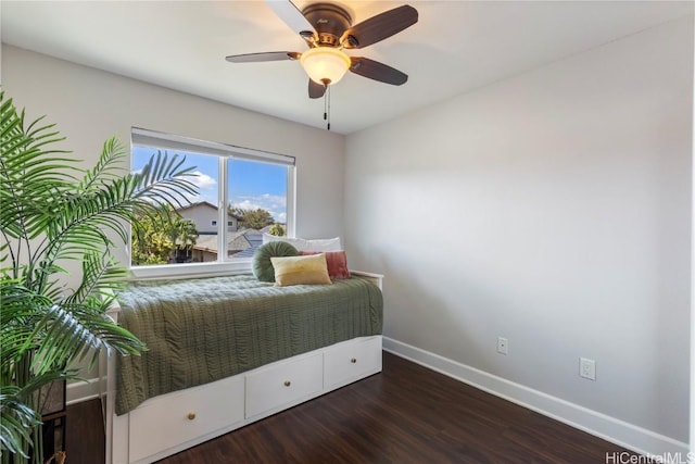 bedroom with baseboards, a ceiling fan, and dark wood finished floors